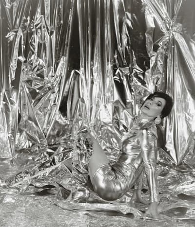 Editorial metallic fashion scene with reflective chrome backdrop