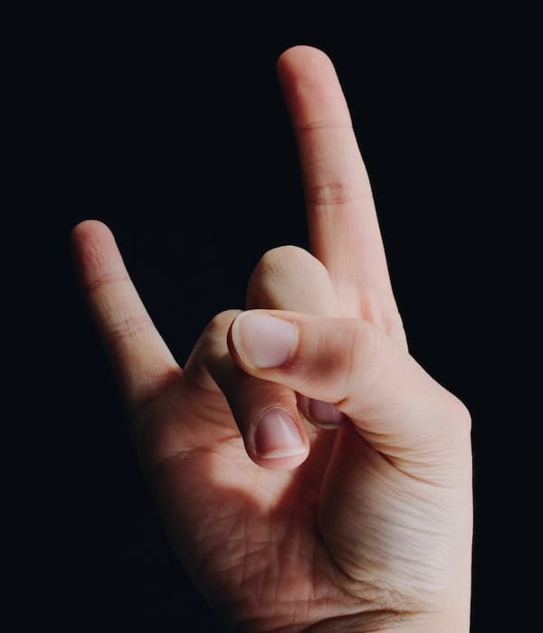 Case Studies FAQ Rock Hand Gesture Hand making a rock and roll gesture against a dark background